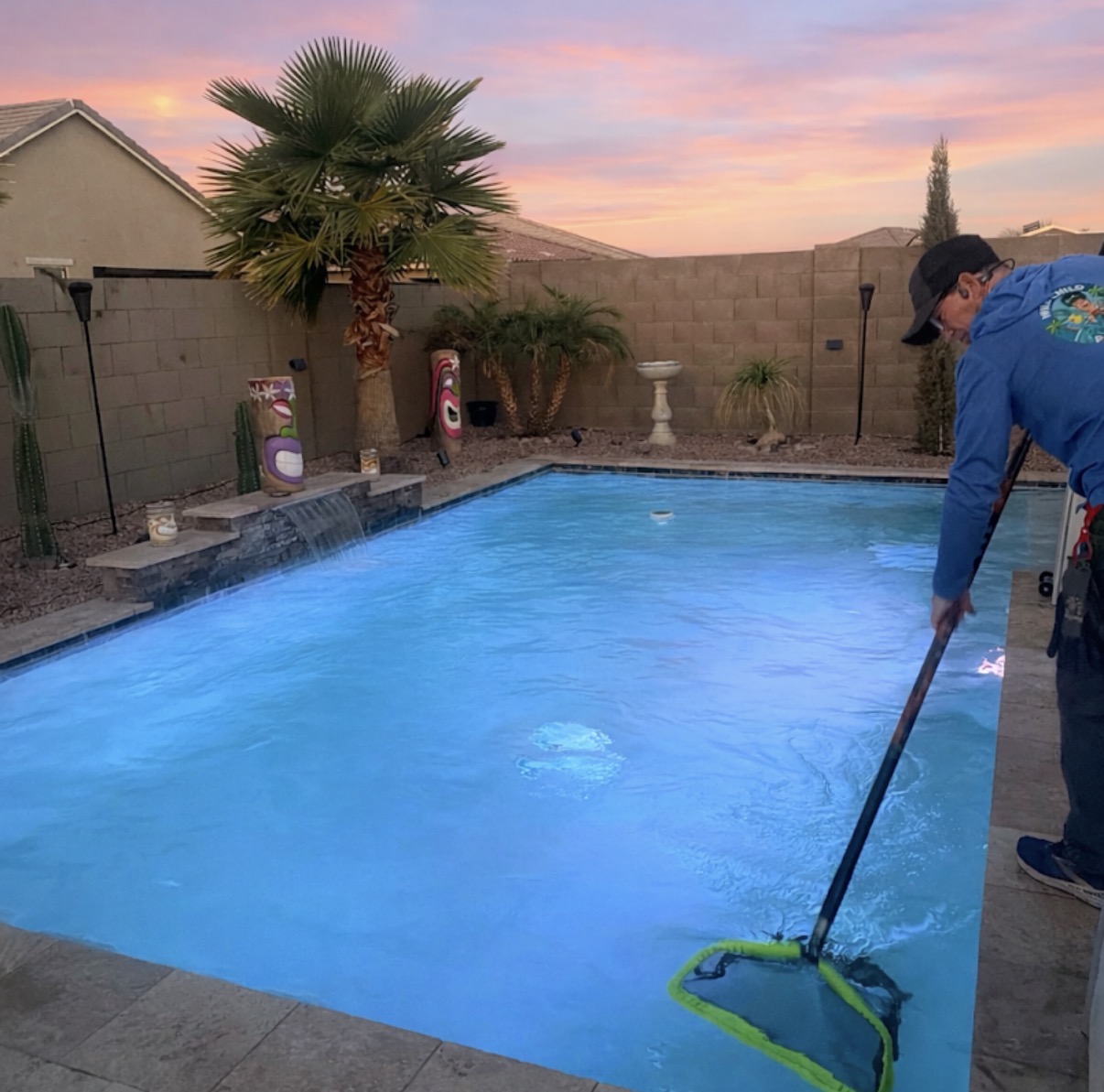 Cody skimming a pool at dusk
