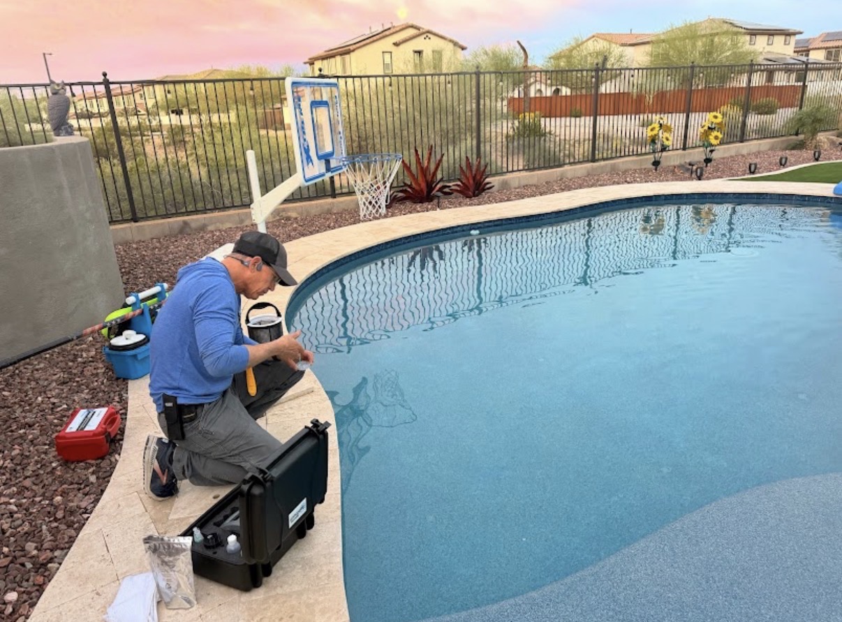 Cody testing pool water at sunset