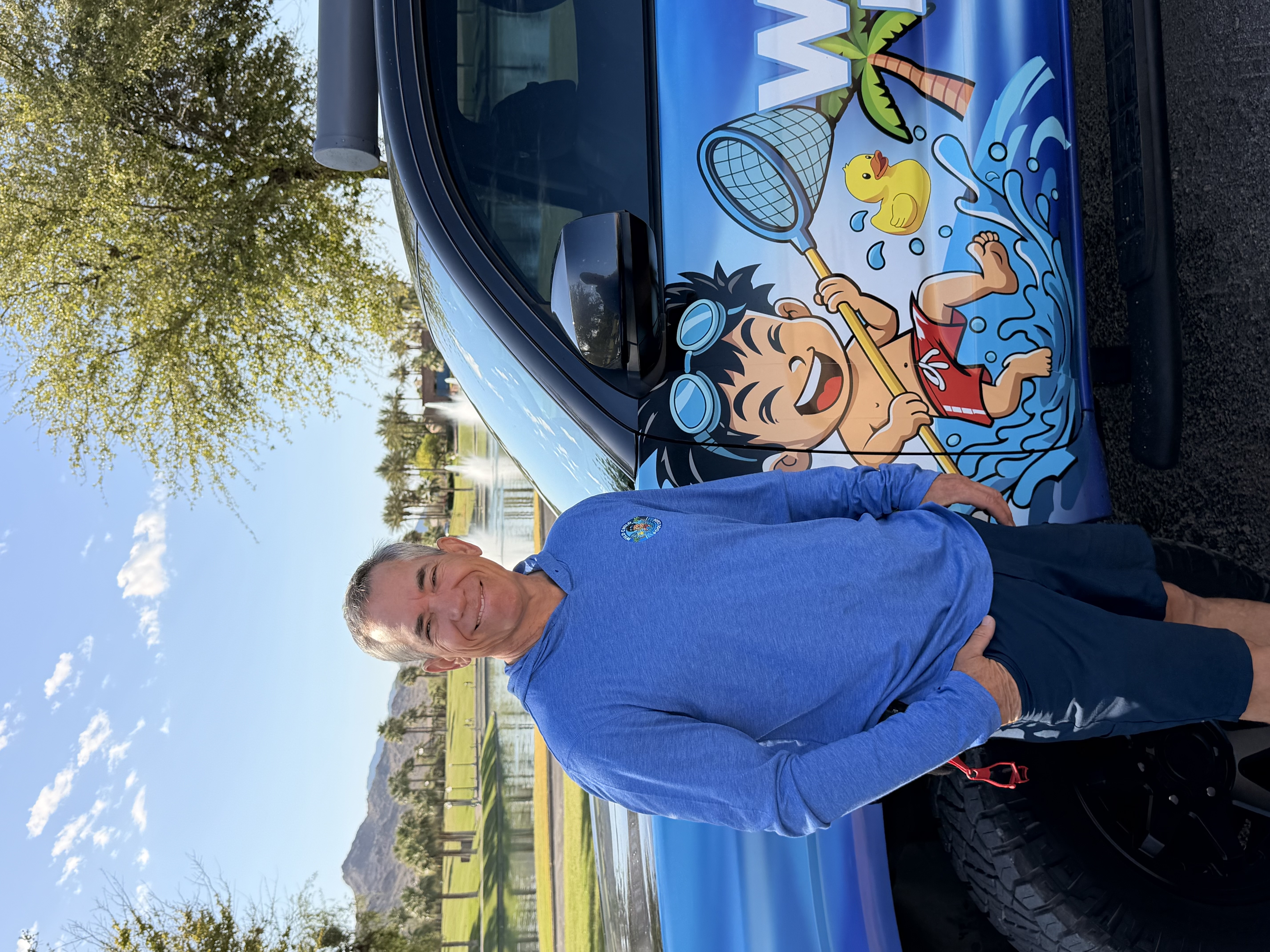 Cody Lang, owner of Wild Child Pool Care, standing in front of his branded truck at Estrella Mountain Ranch